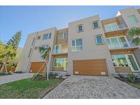 Modern three-story townhouses with attached garages and paved driveways at 1720 Alderman St, Sarasota, FL 34236