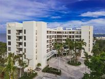 An aerial view of a luxurious condo building with water access at 1930 Harbourside Dr # 152, Longboat Key, FL 34228