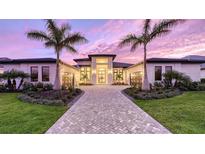 Stunning two-story home with a brick paver driveway and lush landscaping at 19439 Beacon Park Pl, Bradenton, FL 34202
