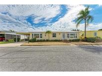Charming single-story home featuring a covered carport and well-maintained landscaping at 2107 Palma Sola Blvd # 84, Bradenton, FL 34209