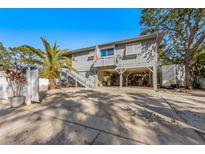 Two-story house with carport and fenced yard at 3511 Camino Real, Sarasota, FL 34239