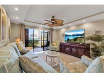 Comfortable living room with plush seating, neutral color palette, and sliding doors to lanai with a ceiling fan at 4119 61St Avenue W Ter # 105, Bradenton, FL 34210