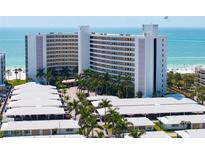 Aerial view of the beachfront building and its surrounding landscape at 6300 Midnight Pass Rd # 606, Sarasota, FL 34242