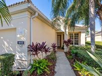 Exterior view of a single-story house with well-manicured landscaping and a walkway at 6642 Tailfeather Way, Bradenton, FL 34203