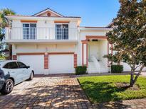 Two-story house with a two-car garage, and a well-manicured lawn at 7335 Fountain Palm Cir # 7335, Bradenton, FL 34203