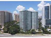 Aerial view of a modern high-rise building with water and city views at 1111 N Gulfstream Ave # 6B, Sarasota, FL 34236