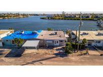 Waterfront home with carport and blue tarp at 19 Seaside Ct, Holmes Beach, FL 34217