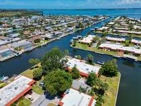 Aerial view of waterfront property with private dock and boat lift at 4098 El Dorado Cv # 4098, Bradenton, FL 34210