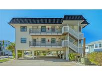 Coastal home on stilts, offering covered parking and easy access to upper-level living spaces at 601 Gulf N Dr # 209, Bradenton Beach, FL 34217