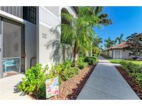 Ground level condo with landscaped walkway and signage at 6705 Grand Estuary Trl # 206, Bradenton, FL 34212