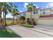 Two-story townhome with attractive landscaping and a paved driveway at 918 River Basin Ct # 101A, Bradenton, FL 34212
