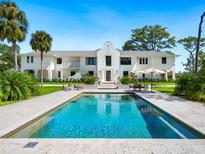 Luxury waterfront home with inviting pool and expansive lawn at 1245 Mill Creek Rd, Bradenton, FL 34212