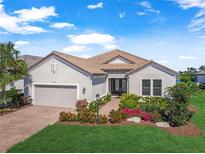 Beautiful one-story home with a large driveway and lush landscaping at 14817 Montello Way, Bradenton, FL 34211