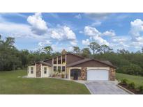 Charming single-Gathering home featuring stone accents, attached garage, and a well-manicured front lawn at 220 Ciboa Ave, North Port, FL 34287