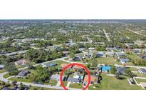 Aerial view of a single-Gathering home with a pool, situated in a residential neighborhood at 6175 Holbrook St, Englewood, FL 34224