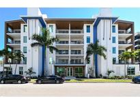 Modern building exterior with palm trees and ample parking at 711 S Palm Ave # 203, Sarasota, FL 34236