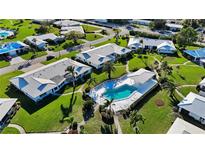 Aerial view of a community with houses, lush landscaping, and a pool at 7402 9Th W Ave, Bradenton, FL 34209