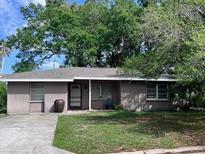 House exterior featuring a single-story home with a gray roof and landscaping at 2141 Clematis St, Sarasota, FL 34239