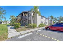 Exterior view of condo building with parking and landscaping at 3609 59Th W Ave # 4045, Bradenton, FL 34210