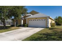 Cute yellow house with a two-car garage and well-maintained lawn at 608 25Th E Dr, Ellenton, FL 34222