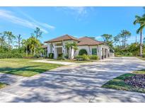 Single-story home with tile roof, driveway, and lush landscaping at 7003 River Club Blvd, Bradenton, FL 34202