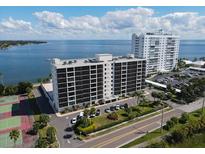 Aerial view of waterfront condo building with tennis courts and parking at 7100 Sunshine Skyway S Ln # 706, St Petersburg, FL 33711