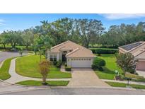 Single-story home with a two-car garage and lush landscaping at 7153 Drewrys Blf, Bradenton, FL 34203