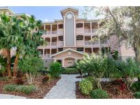 Three-story condo building with landscaped grounds and walkway at 5209 Manorwood Dr # 3A, Sarasota, FL 34235