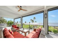 Relaxing waterfront deck featuring wicker furniture and stunning water views at 7418 Westmoreland Dr, Sarasota, FL 34243