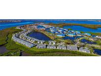 Aerial view of waterfront community with lush landscaping and numerous homes at 807 Waterside Ln, Bradenton, FL 34209