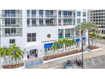 Modern building exterior with pool and lush landscaping at 1233 N Gulfstream Ave # 301, Sarasota, FL 34236