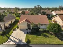 Aerial view of single-story home with tile roof, showcasing the surrounding neighborhood at 148 Inlets Blvd # 148, Nokomis, FL 34275
