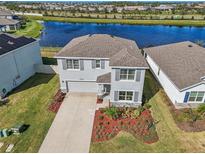 Beautiful two-story home boasts lush landscaping and a serene water view at 17113 Reserva Dr, Bradenton, FL 34211