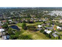 Aerial view of single-story home on a golf course at 3212 Pine Valley Dr, Sarasota, FL 34239