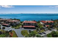Aerial view of waterfront condo community with lush landscaping and parking at 3420 Wild Oak Bay Blvd # 118, Bradenton, FL 34210