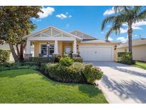 Beautiful one-story home with a two-car garage and well-manicured lawn at 11822 Forest Park Cir, Bradenton, FL 34211