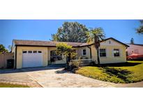 Charming one-story home features an attached garage and a well-maintained yard with mature landscaping at 3405 Highland W Ave, Bradenton, FL 34205