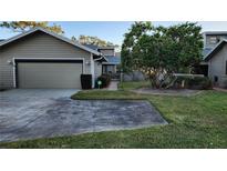 Tan colored house with a two car garage and walkway at 3409 Avenida Madera # A, Bradenton, FL 34210