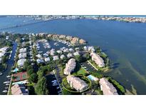 Aerial view of waterfront community, showing building, marina, and tennis courts at 3920 Mariners Way # 311C, Cortez, FL 34215