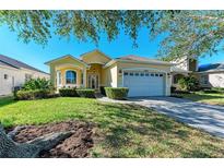 Single story house with a two car garage and lush landscaping at 11120 Sanctuary Dr, Bradenton, FL 34209