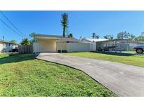 House with carport and spacious front yard at 4930 George Ave, Sarasota, FL 34233