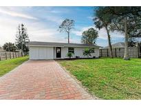 Newly renovated home with brick paver driveway and spacious lawn at 875 Royal Rd, Venice, FL 34293