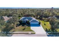 Single-Gathering home with two-car garage and spacious backyard, situated on a tree-lined street at 13618 2Nd Ne Ave, Bradenton, FL 34212