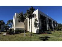 Modern condo building with palm trees and well-maintained landscaping at 4119 61St Avenue W Ter # 308, Bradenton, FL 34210
