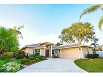 Attractive single-story home with a two-car garage and landscaped front yard at 5715 Fern Oak Ct, Sarasota, FL 34232