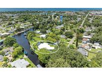 An aerial view of the beautiful waterfront home with a private pool, lush greenery and easy canal access at 608 69Th W Ave, Bradenton, FL 34207