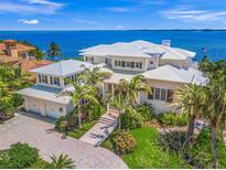 Luxury waterfront home with expansive bay views, private dock, and lush landscaping at 641 Key Royale Dr, Holmes Beach, FL 34217