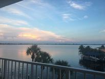 Stunning water view from private balcony, showcasing serene sunset over calm waters at 9923 Manatee W Ave # 4, Bradenton, FL 34209