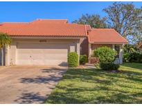 Cute condo with a large, attached garage and well-manicured lawn at 4002 Wilshire E Cir # 90, Sarasota, FL 34238