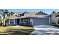 Gray two-story house with a two-car garage and a porch at 4042 Kingsfield Dr, Parrish, FL 34219